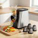 Vegetable chopper with sliced vegetables on a cutting board in a kitchen setting