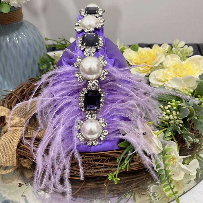 Decorative purple cone with pearls and feathers on a floral background