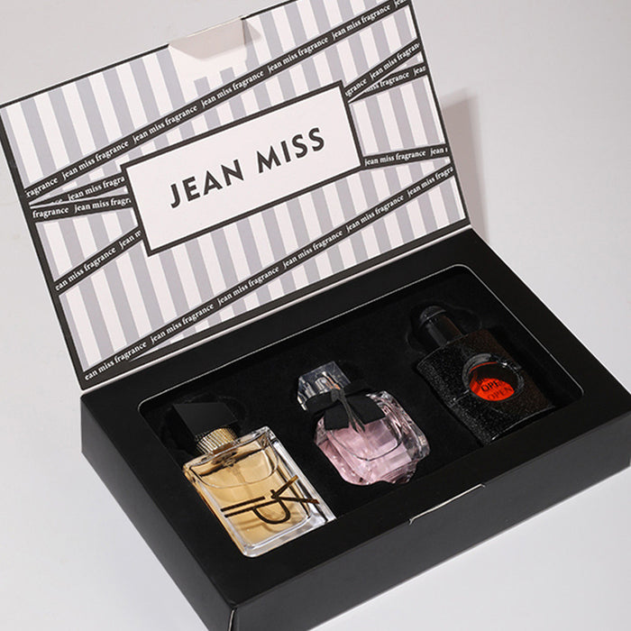 Three perfume bottles in a 'Jean Miss' branded box on a light gray background