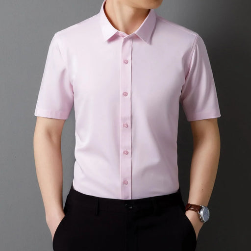 Person wearing a light pink short-sleeve dress shirt against a gray background