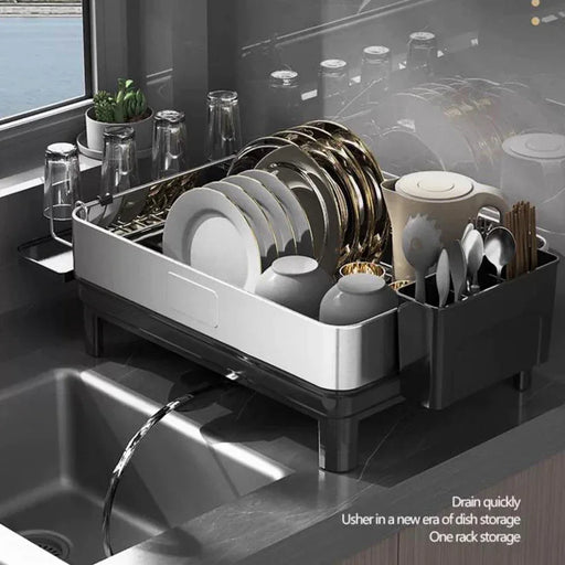 Dish drying rack with dishes on a kitchen counter next to a sink.