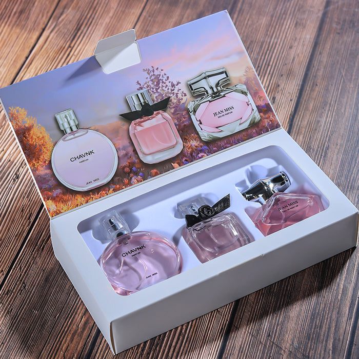Perfume set with six bottles in a box on a wooden surface