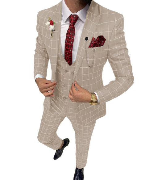 Man wearing a beige checkered suit with a red tie and pocket square on a white background