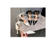 Three high-heeled shoes displayed on a gray surface with text overlay.