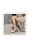 Woman in a white dress and high-heeled shoes with text about fashion trends on a gray background