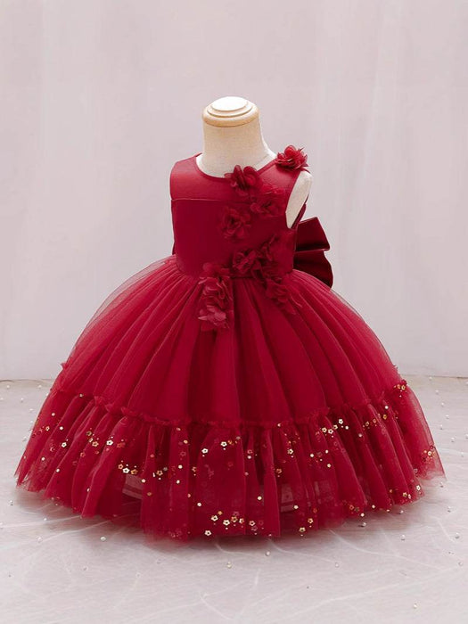 Red flower girl dress with sequins on a mannequin against a white background