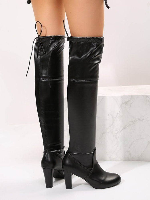 Black knee-high boots on a white background