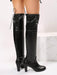 Black knee-high boots on a white background
