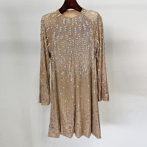 Gold sequin dress on a hanger against a white background