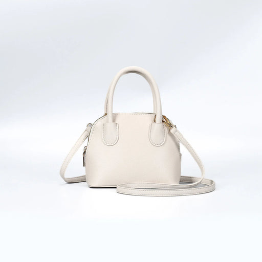 White handbag with a strap on a light gray background