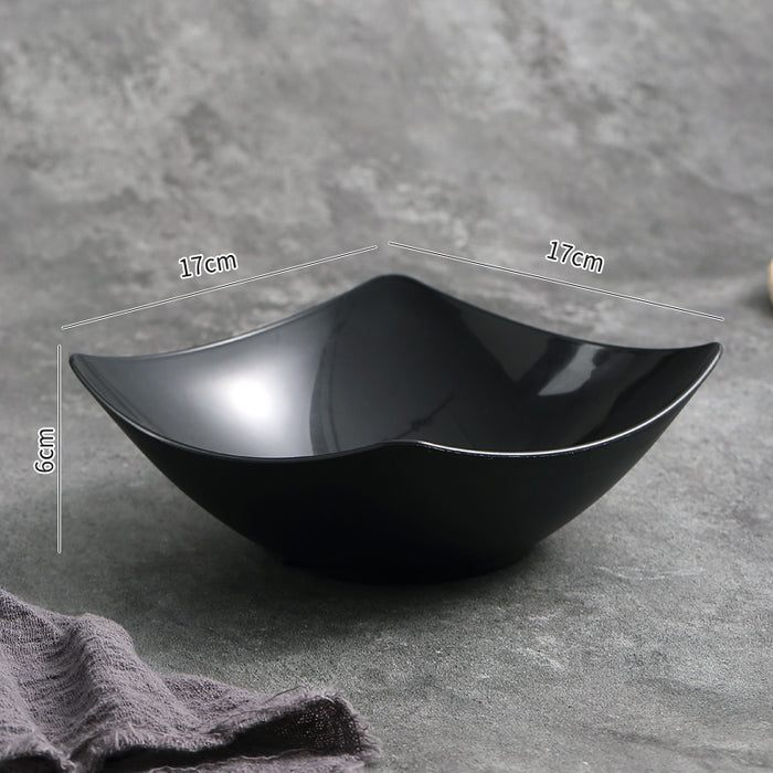 Black ceramic bowl with dimensions on a gray background
