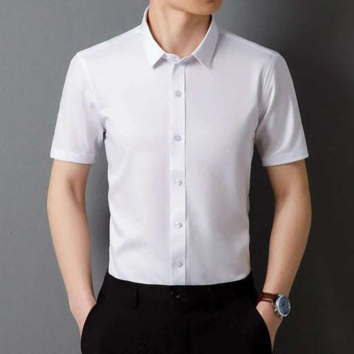 Person wearing a white short-sleeve dress shirt against a dark background