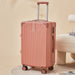 Pink suitcase with wheels on a beige background