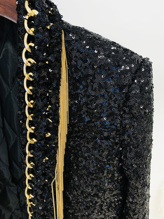 Black sequined jacket with gold trim on a plain background