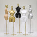 Set of five mannequins in various colors on stands against a white background