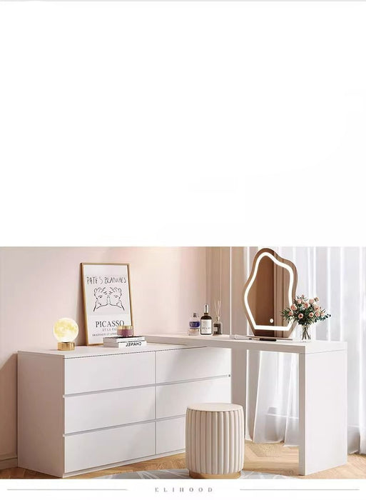 Modern bedroom setup with a vanity table, mirror, and decor items.