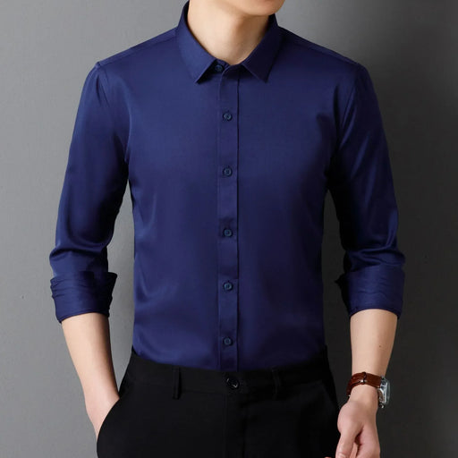 Navy blue dress shirt worn by a person against a gray background