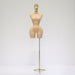 Mannequin torso on a stand with a gold head against a white background