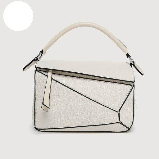 White handbag with geometric design on a light gray background