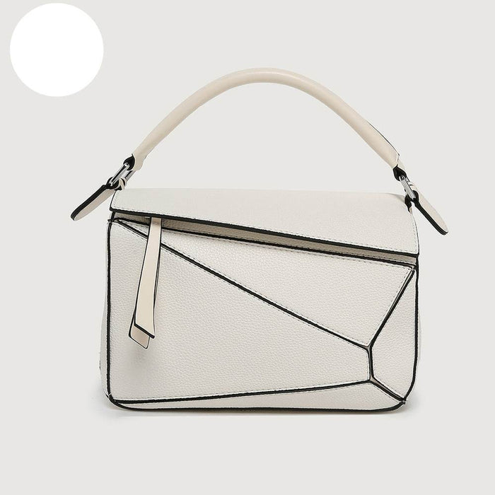 White handbag with geometric design on a light gray background