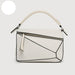White handbag with geometric design on a light gray background