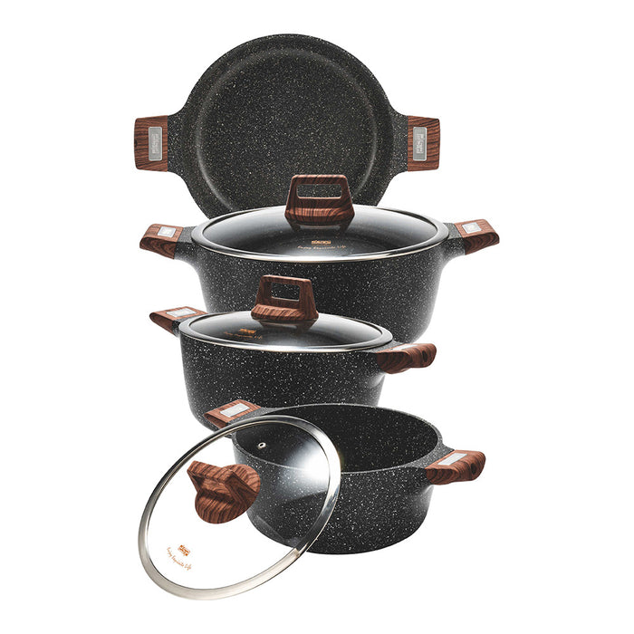 Set of black speckled cookware with wooden handles on a white background