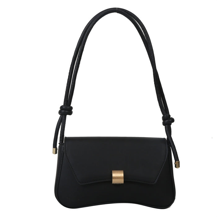 A black leather shoulder bag with a curved flap, a gold-tone front clasp, and a long black braided strap with knotted details, shown against a plain white background.