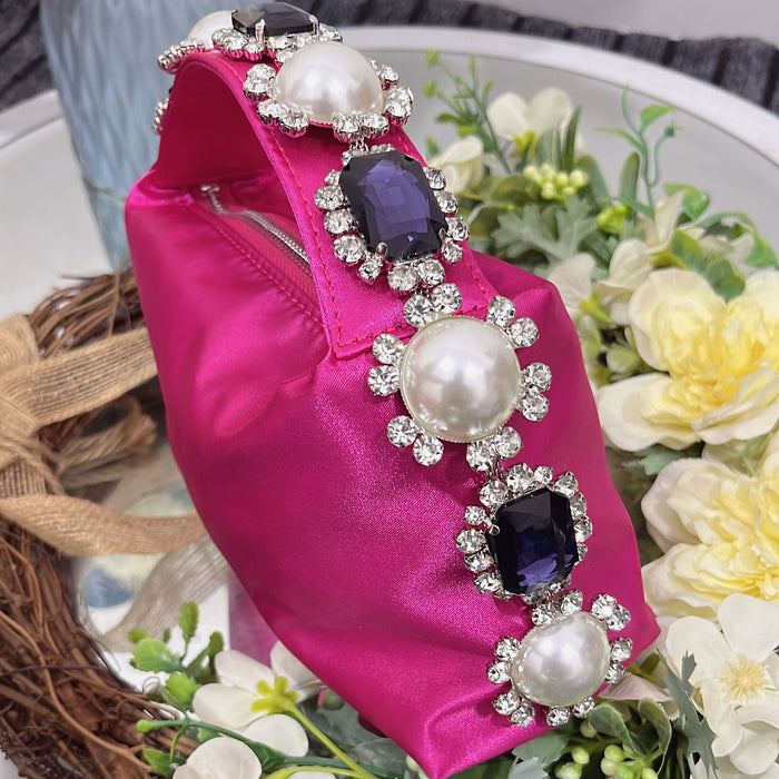 Pink dress with decorative pearls and gemstones on a floral background