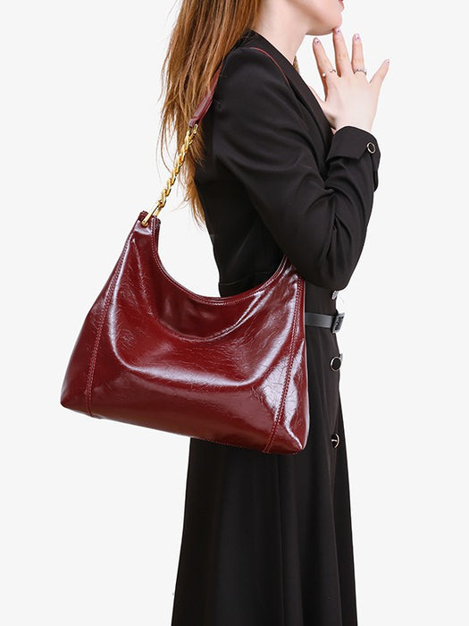 Person holding a red handbag against a white background