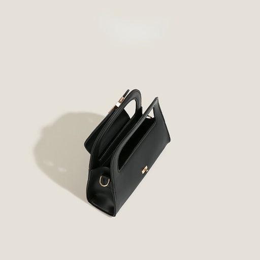 Black handbag on a light beige background