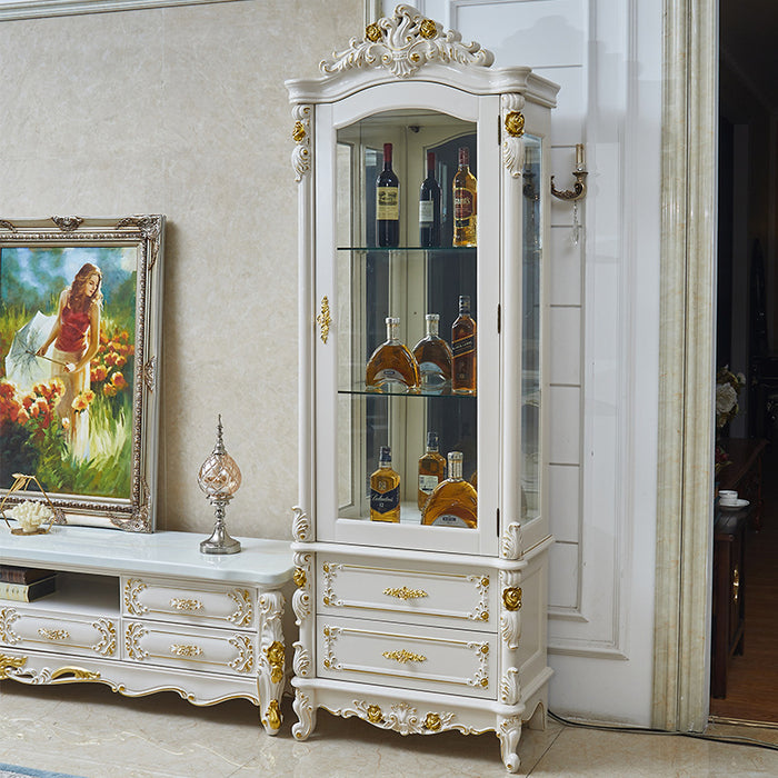 Decorative white cabinet with gold accents in a room with a painting and furniture.