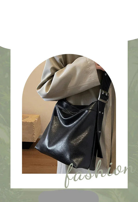 Black leather handbag with beige coat on a white background, featuring brand name 'XINDING'.