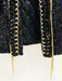 Black sequined clutch with gold trim on a white background