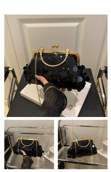 Black sequin handbag with gold accents on a black surface, displayed against a neutral background.