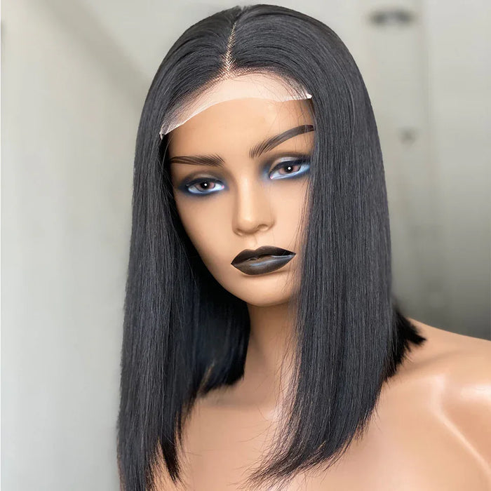 Mannequin head with a black straight wig on a plain background