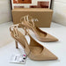 Beige high-heeled shoes with an ankle strap on a white surface, next to a Zara box.