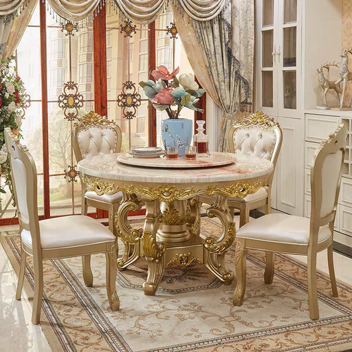 Elegant dining room with a gold and marble table and chairs.