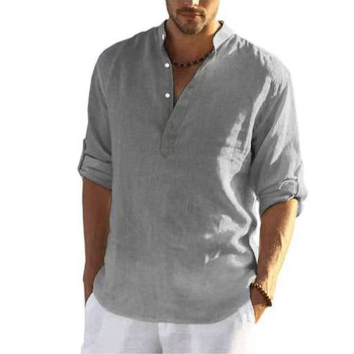 Man wearing a gray short-sleeve shirt with rolled-up sleeves on a white background