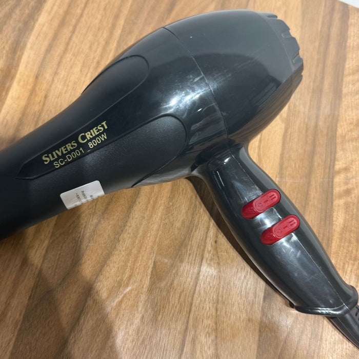 Black hair dryer with red buttons on a wooden surface, featuring 'Slivers Crest' branding.