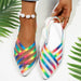 Multicolored strappy shoes with a white background