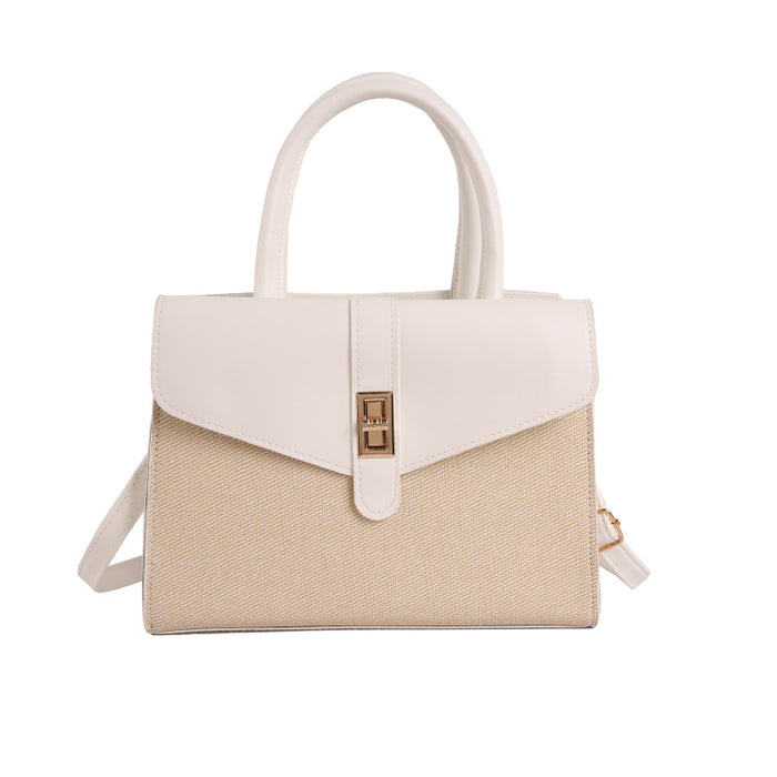 A structured handbag with a cream-colored faux leather top handle and flap, combined with a beige woven-texture lower body panel, featuring a gold-tone turn-lock clasp and a matching shoulder strap, set against a plain white background.
