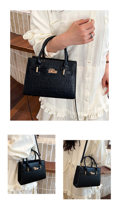 A black crocodile-embossed leather handbag with gold-tone hardware, shown being carried by a person wearing a white blouse. The image includes a large main view and two smaller side views showing different angles of the handbag.