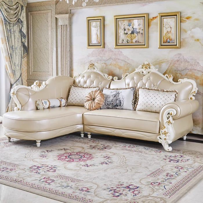 Luxurious cream-colored sofa in a stylish living room with decorative pillows and framed artwork.