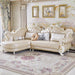 Luxurious cream-colored sofa in a stylish living room with decorative pillows and framed artwork.