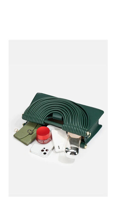 Green capacity display bag with various items on a white background