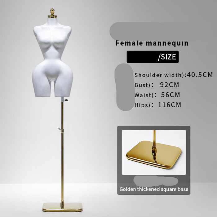 White female mannequin with gold base on a gray background