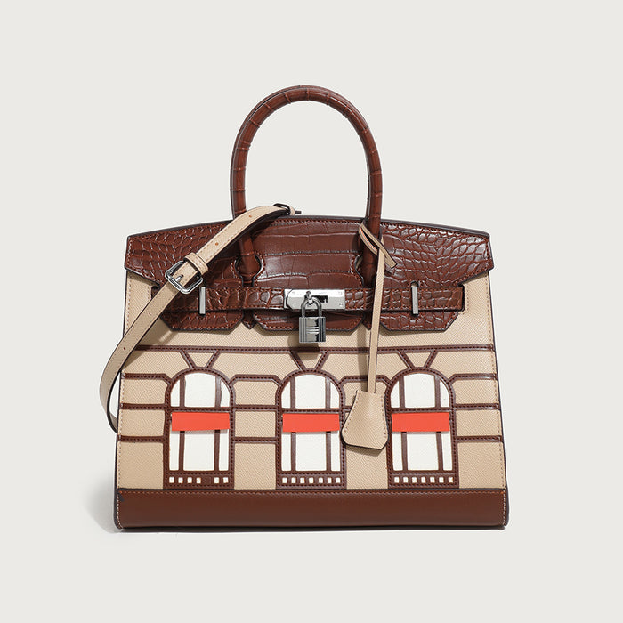 A handbag with a structured design featuring a mix of colors and geometric patterns, with a shoulder strap and a brand-embossed lock.