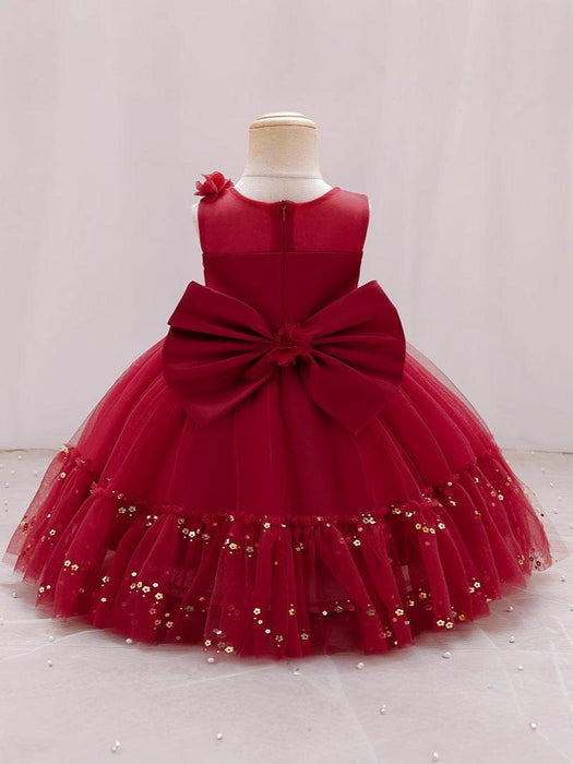 Red dress with a large bow on a mannequin against a light background