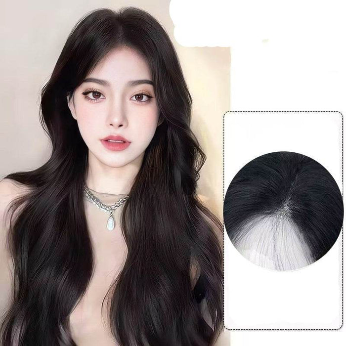 Woman with long black hair and close-up of hair root showing blend with natural hair.