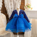 Blue dress with a large bow on a mannequin against a decorative background